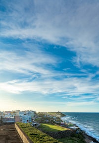 a man is flying a kite over the ocean